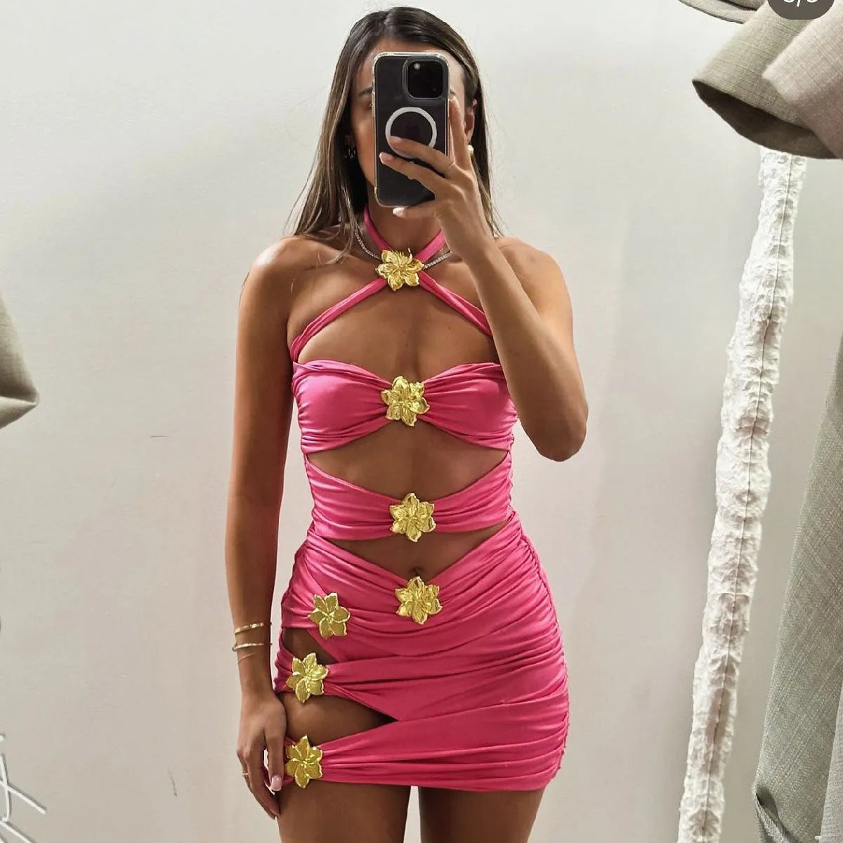 Women's solid colour one-piece swimsuit with attached short skirt in black, showing high-waisted fit and hollow-out tube top design.