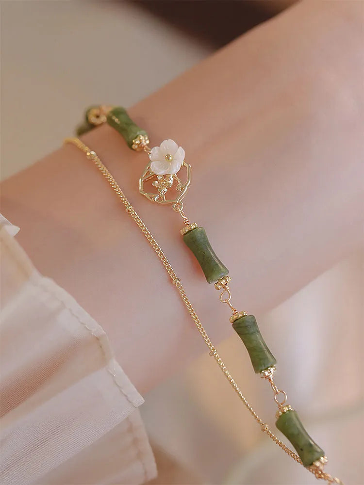 Natural olivine bracelet with Chinese double layer design featuring twin bells of Ireland olive branch elements