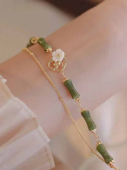 Natural olivine bracelet with Chinese double layer design featuring twin bells of Ireland olive branch elements