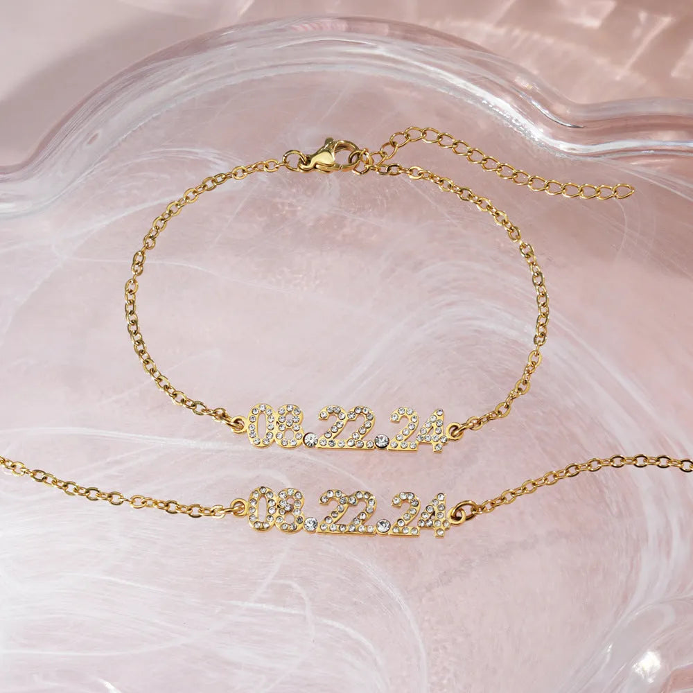 Stainless steel digital bracelet with diamond-set numbers on a wrist, showing gold, rose gold, and steel colour options.