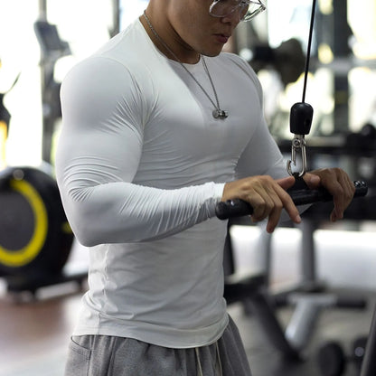 Men's black fitness tights with long sleeves and slim fit design for gym workouts and running