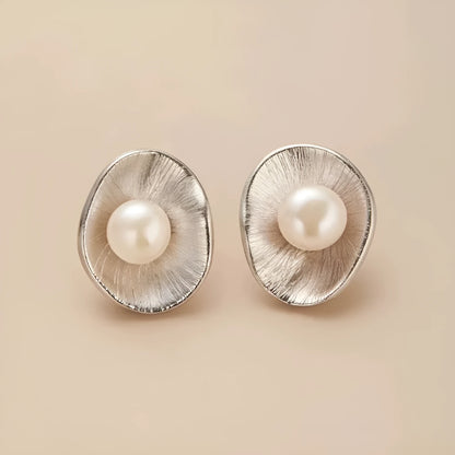Silver geometric needle earrings with pearl decorative elements on female model