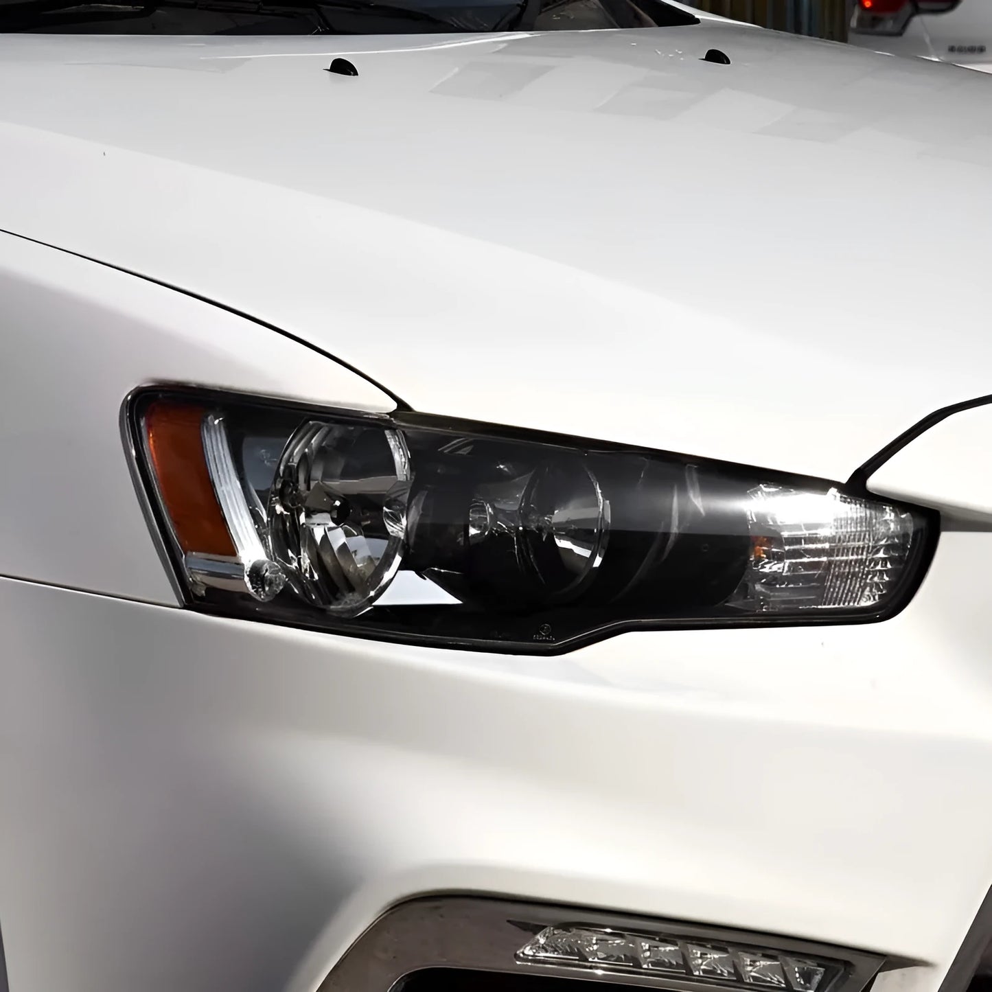Transparent plastic car headlight housing cover with dimensions 50mm by 30mm by 20mm.