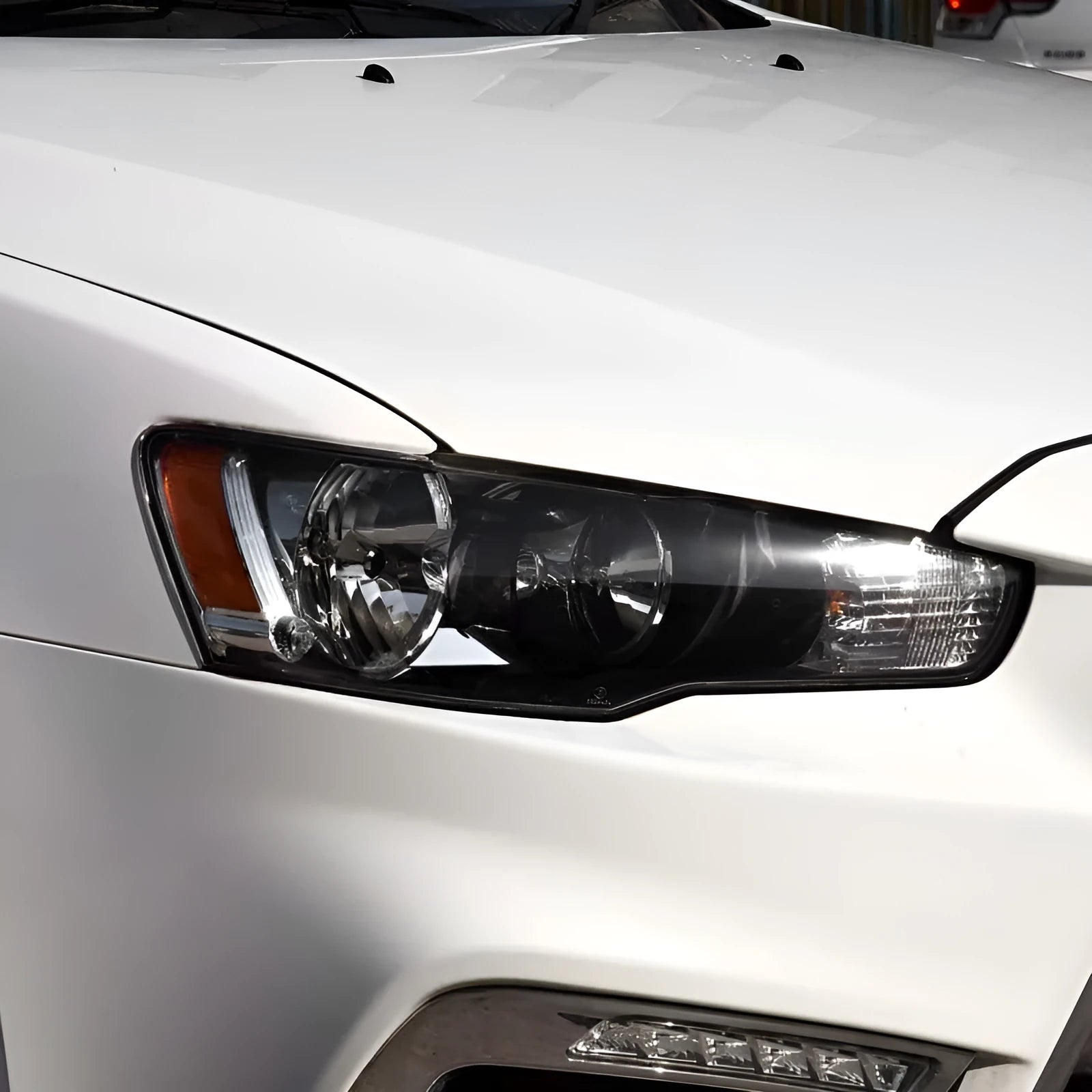 Transparent plastic car headlight housing cover with dimensions 50mm by 30mm by 20mm.