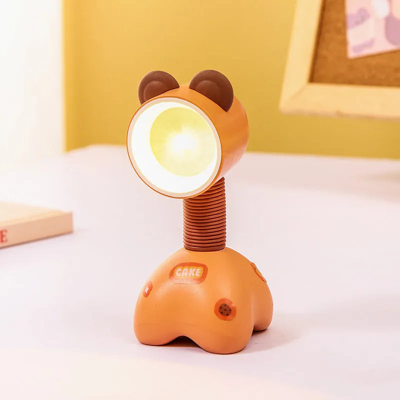 Colourful cartoon character magnetic DIY night light on a desk with adjustable head.