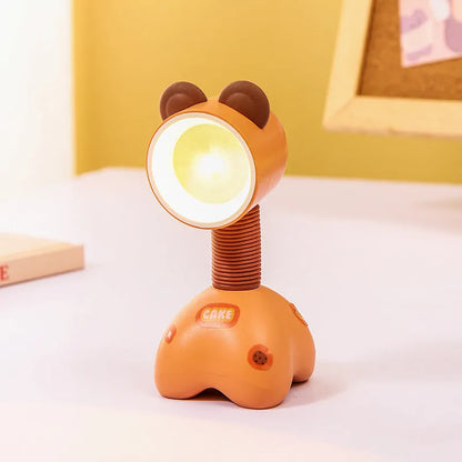 Colourful cartoon character magnetic DIY night light on a desk with adjustable head.