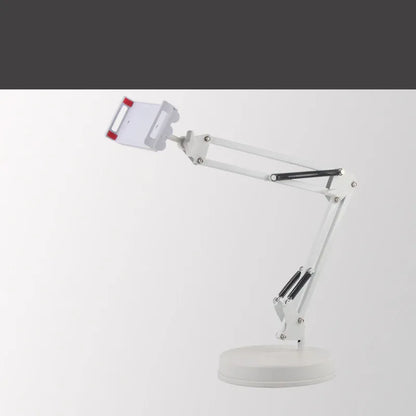 Black metal adjustable phone and tablet stand with a heavy round base on a wooden desk