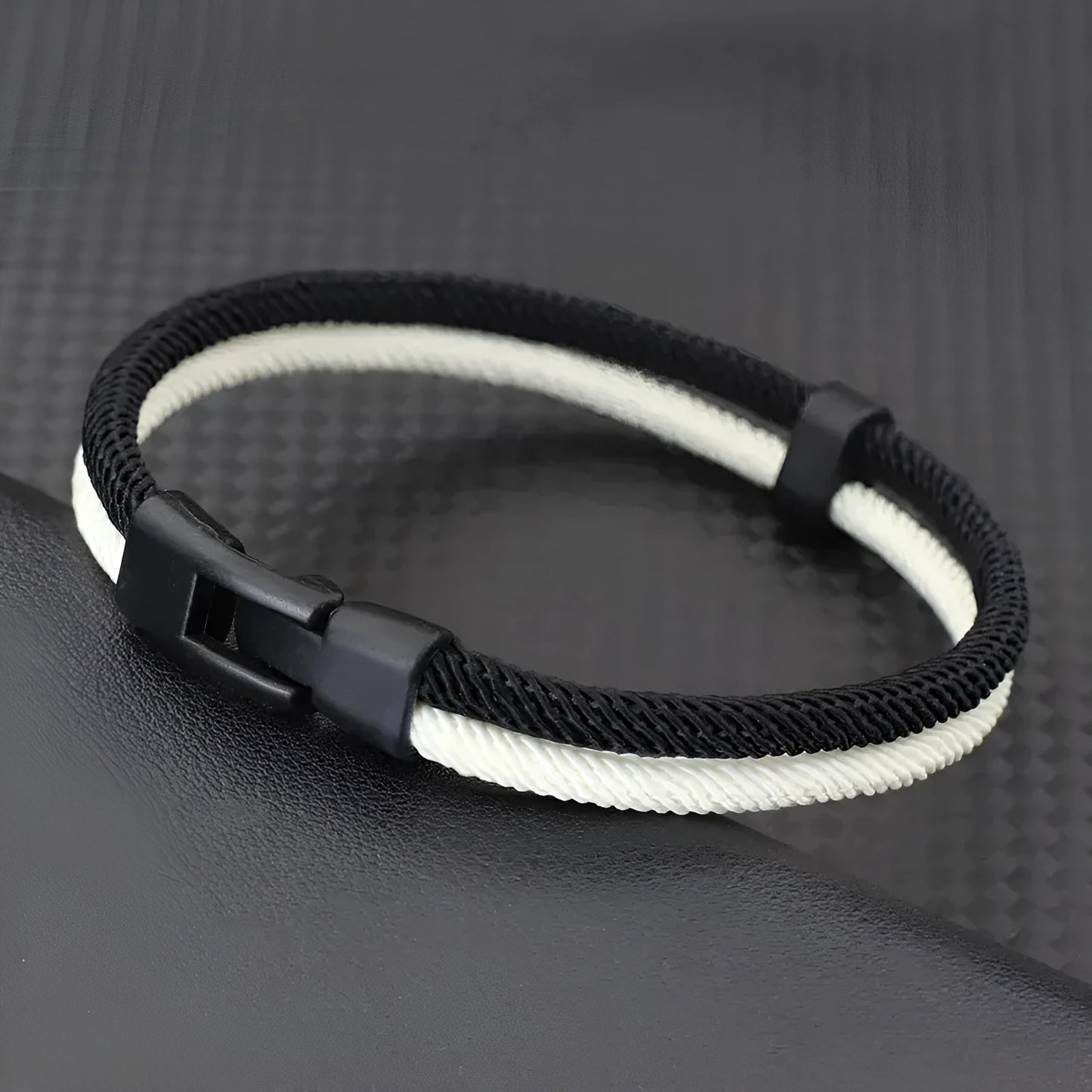 Black and white handmade woven Milan rope hand strap with alloy metal hardware.