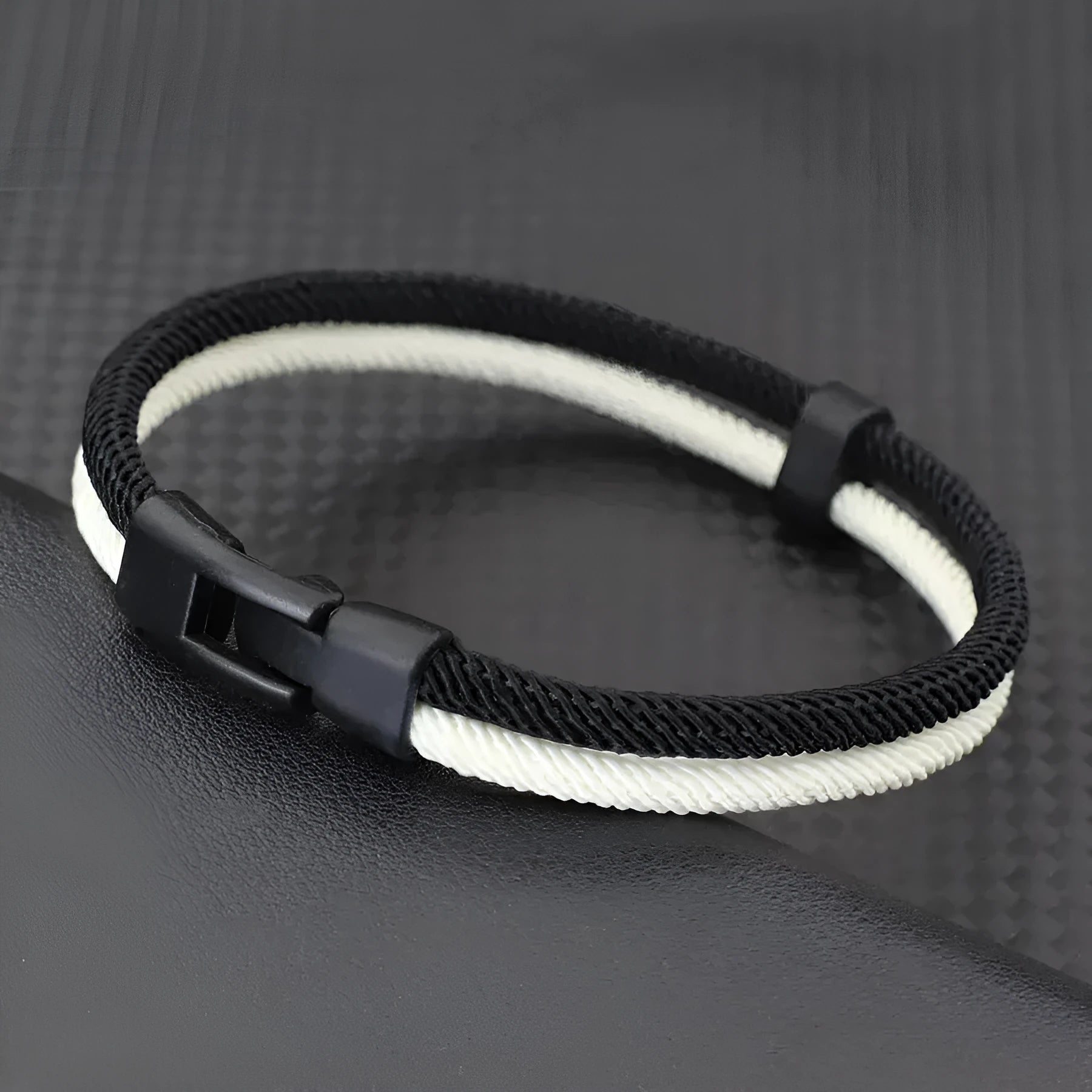 Black and white handmade woven Milan rope hand strap with alloy metal hardware.
