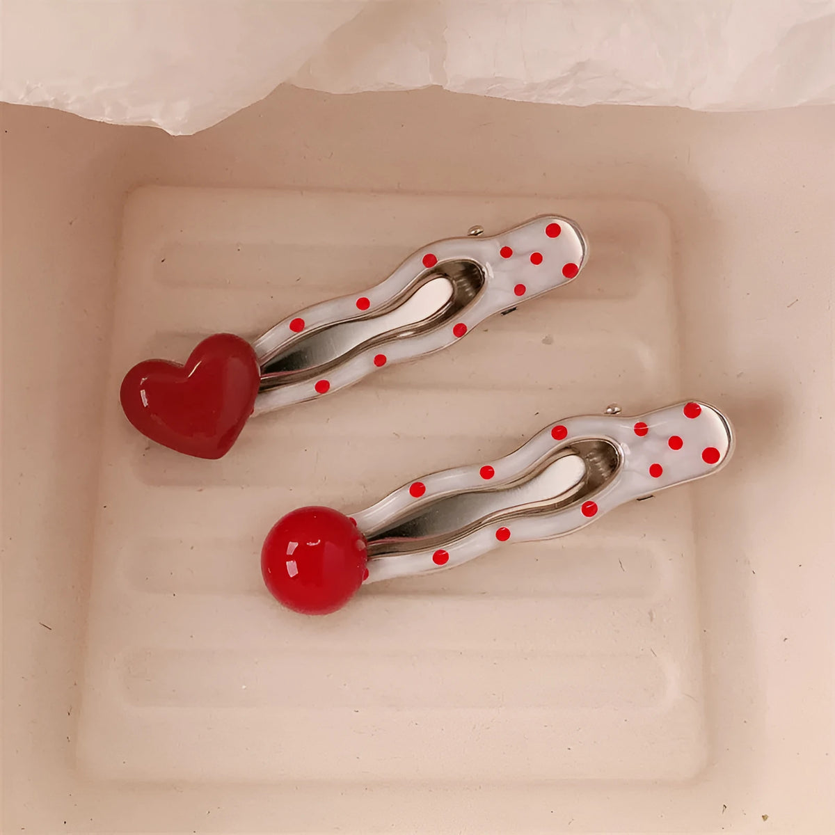 Red love heart-shaped hair barrette clip with retro white dots on a willow leaf-shaped base.