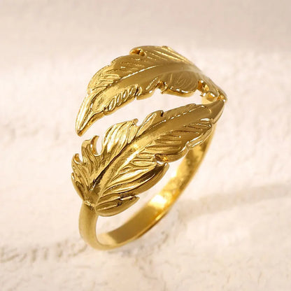 Women's stainless steel feather fashion ring with adjustable opening in silver or gold colour