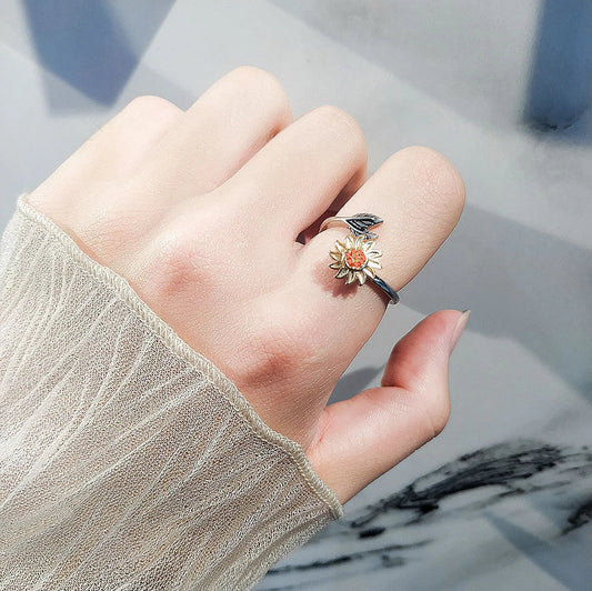 Dazzling silver sunflower ring with a 360-degree rotating design, perfect for elevating any outfit with elegance and style.