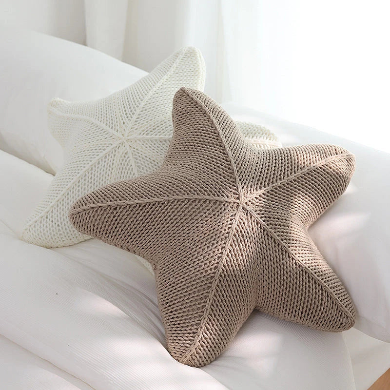 Artfully hand-knitted starfish-shaped cushion in a range of sophisticated colour options, providing plush comfort and coastal charm for any living space.