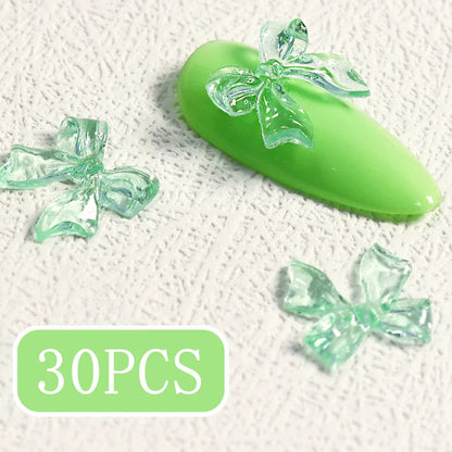 Charming candy-coloured bow nail charms in various colours, perfect for adding a playful touch to your manicure