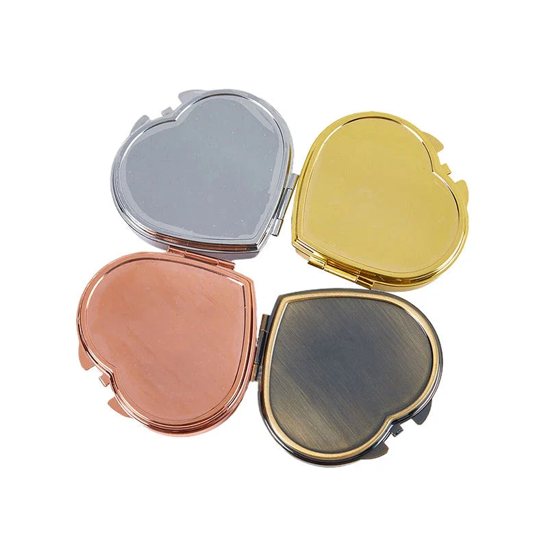 Heart-shaped metal pill box with built-in mirror for convenient storage and touch-ups on the go