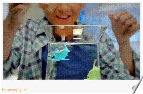 Electric robotic fish swimming in a fishbowl, mimicking the natural movements of a real fish