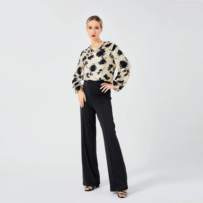 Elegant ladies' blouse with a printed pattern, dropped collar, and long sleeves in a classic white colour