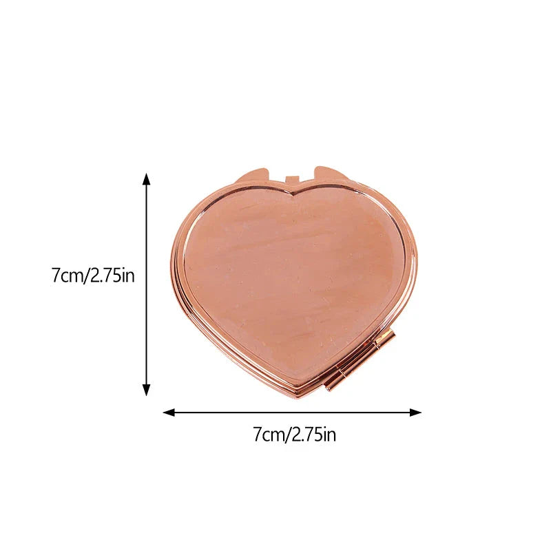 Heart-shaped metal pill box with built-in mirror for convenient storage and touch-ups on the go