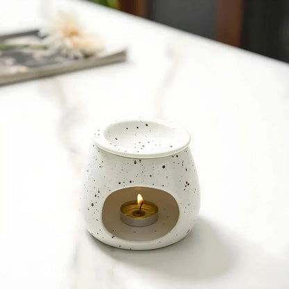 Elegant ceramic aroma diffuser with a unique spotted glaze design, perfect for creating a calming atmosphere in any room.