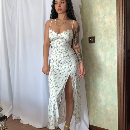 Elegant floral midi dress with slit, adjustable suspender straps, and luxurious polyester fabric for a sophisticated summer look.