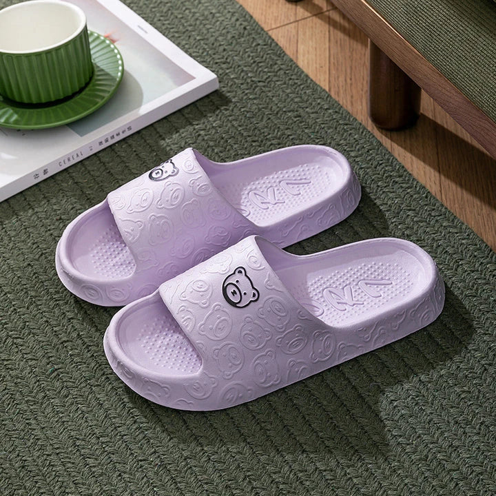 Cosy bear paw slippers in purple colour with soft, plush lining for relaxing indoor wear