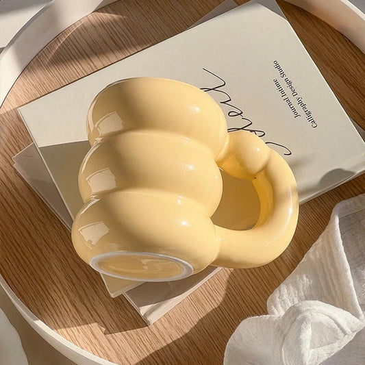 Charming ceramic coffee mug with a circular bubble design in a light blue colour, perfect for morning beverages in the UK