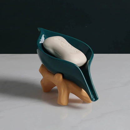 Elegant ceramic leaf-shaped soap holder with a sturdy base, adding a touch of nature-inspired sophistication to any bathroom