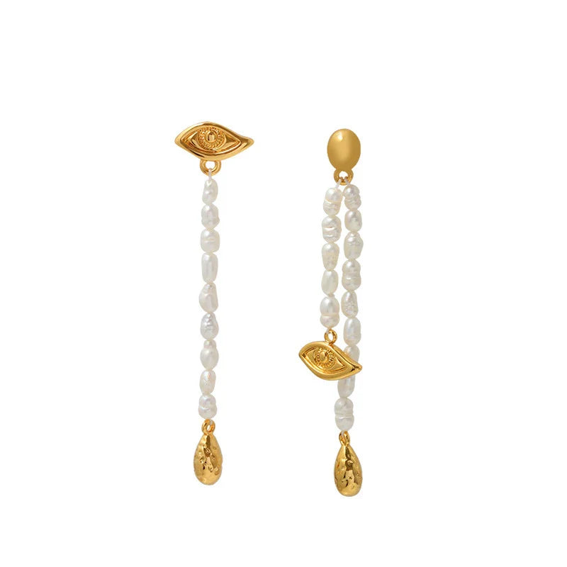 Pair of elegant, asymmetrical pearl earrings with a luxurious and sophisticated design