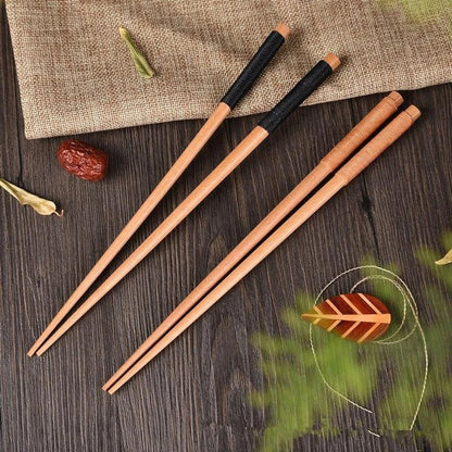Pair of natural chestnut wood chopsticks with a rustic, earthy tone and elegant design