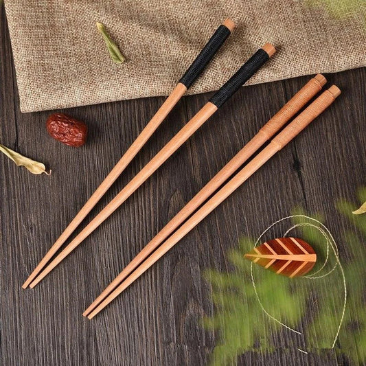 Pair of natural chestnut wood chopsticks with a rustic, earthy tone and elegant design