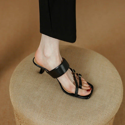 Elegant black genuine leather high heel open toe sandals with a sleek silhouette and chic buckle detail