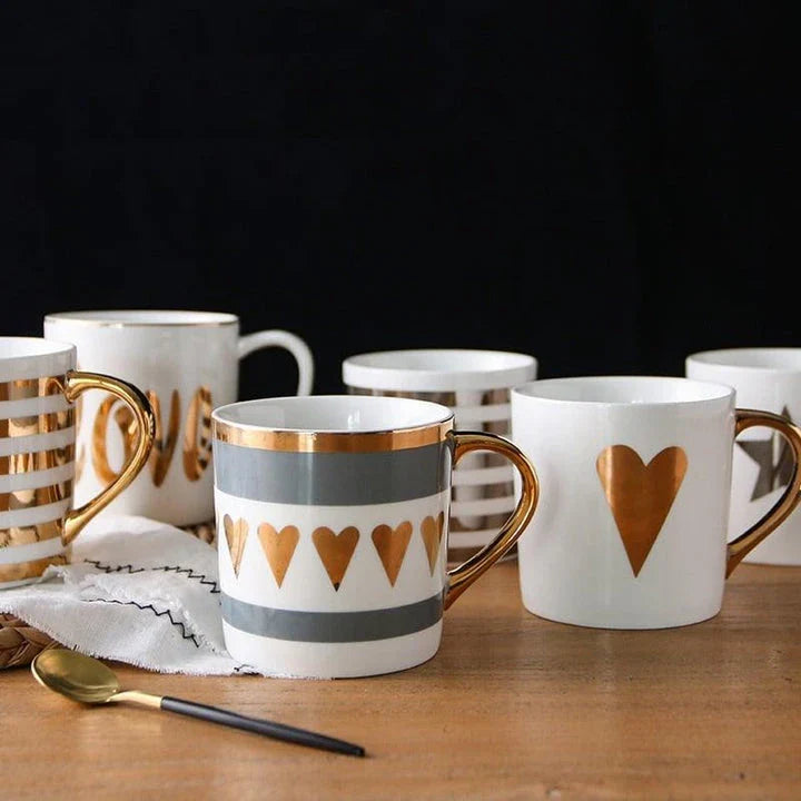 Elegant porcelain coffee mug with a lustrous gold heart design, perfect for enjoying hot beverages in style.