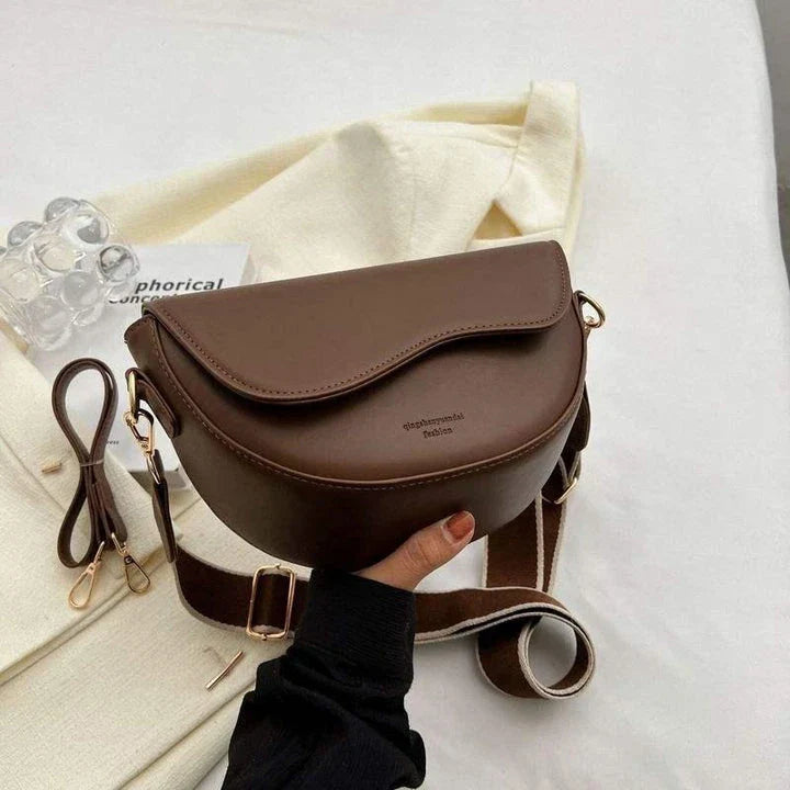 A stylish pillow-shaped shoulder bag made of high-quality PU leather, featuring a crossbody and messenger design for versatile use.