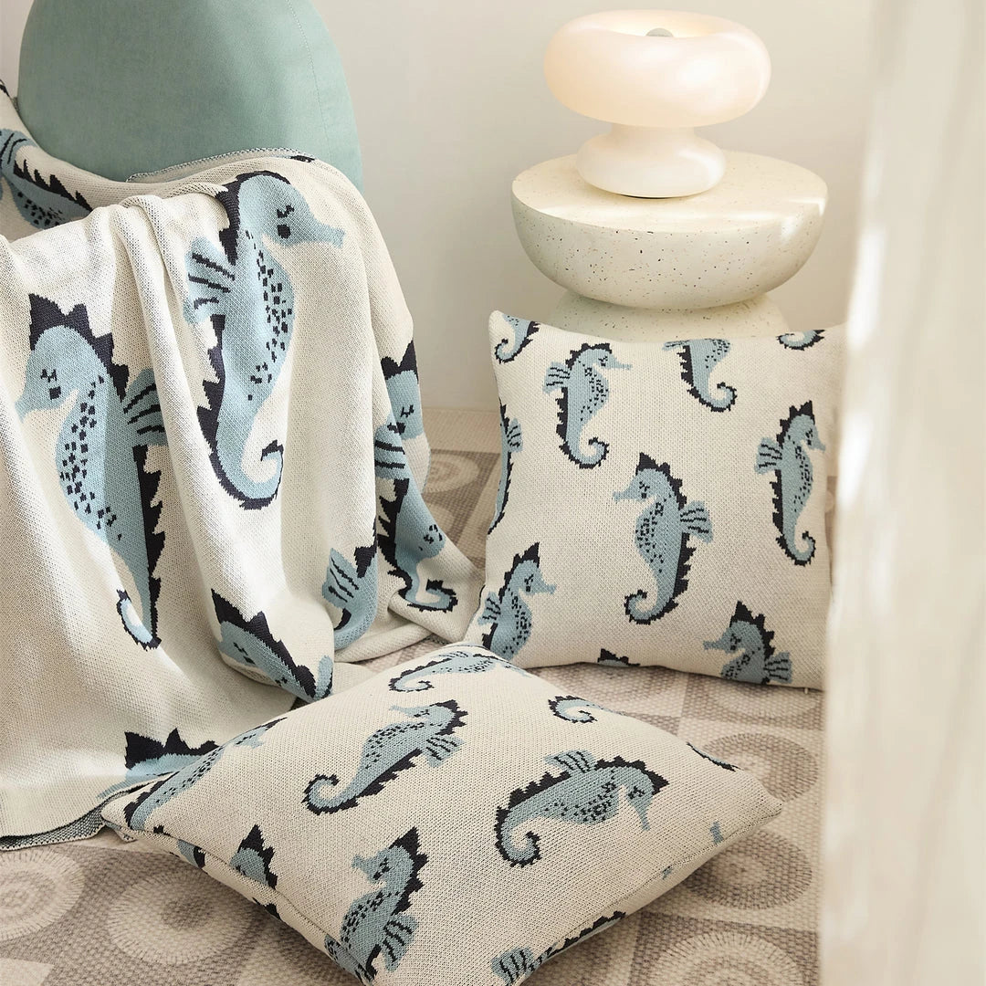 Cosy Sea Horse Cotton Throw Blanket in pink and lake blue colours, featuring a playful sea horse pattern and jacquard weave design.