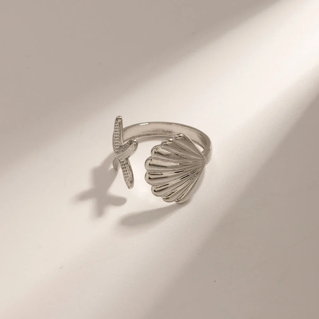Adjustable stainless steel ring with starfish and shell accents, perfect for beach and casual wear