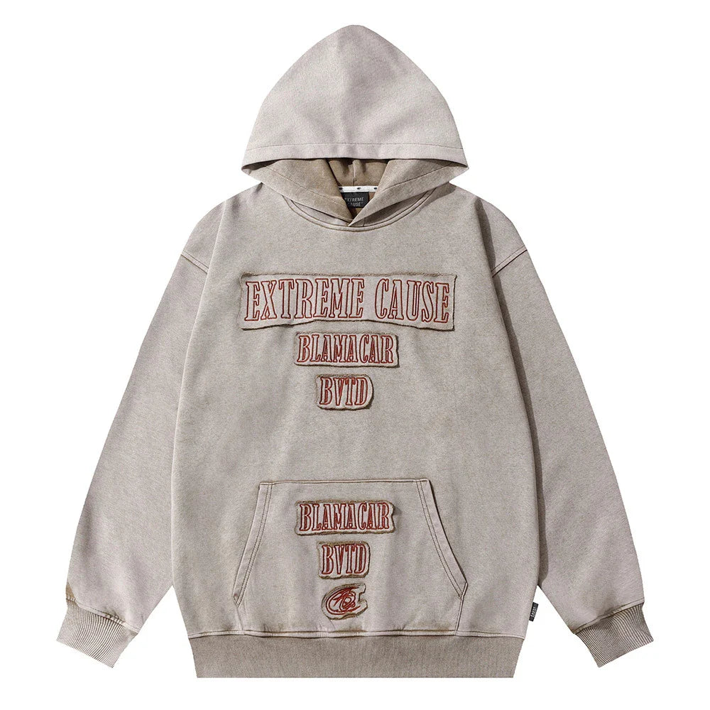 A premium cotton pullover hoodie with an embroidered letter patch in a variety of classic autumn colours
