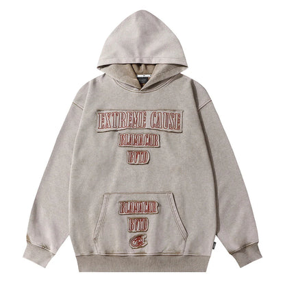 A premium cotton pullover hoodie with an embroidered letter patch in a variety of classic autumn colours