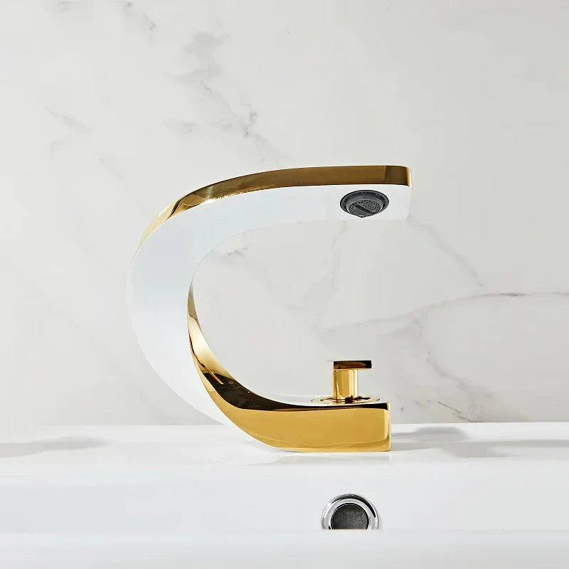 Elegant brass gold and white bathroom basin faucet with sleek, contemporary design