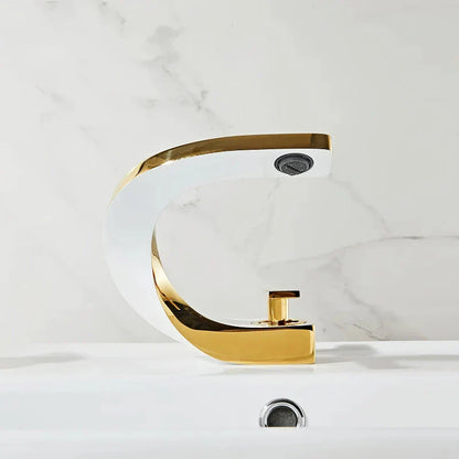 Elegant brass gold and white bathroom basin faucet with sleek, contemporary design
