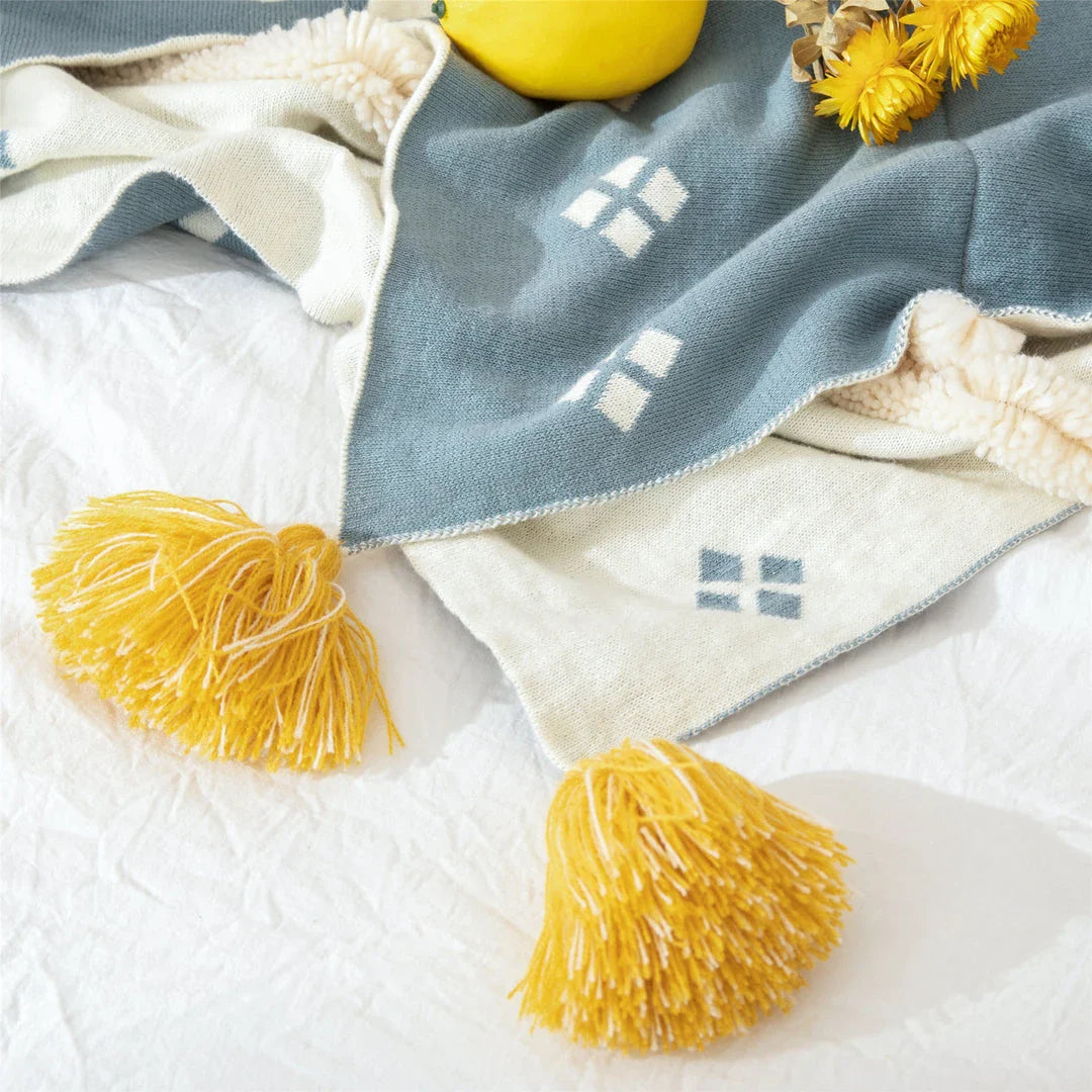 Cosy cotton tufted throw blanket with a geometric pattern and tassels in a soft yellow colour