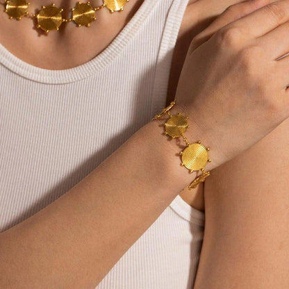 Close-up of a luxurious 18K gold plated stainless steel bracelet with an elegant palace-style design