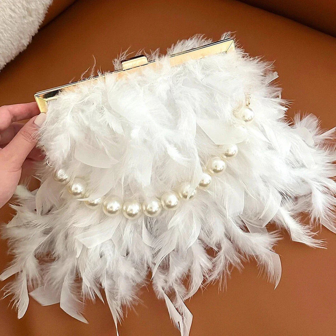 Elegant feather clutch bag with pearls and metal chains, a versatile and sophisticated evening accessory