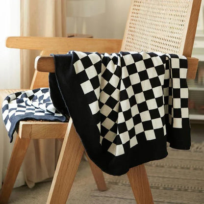 Cosy checkerboard plaid cotton knitted blanket in earthy tones of green, khaki, and black for stylish home decor