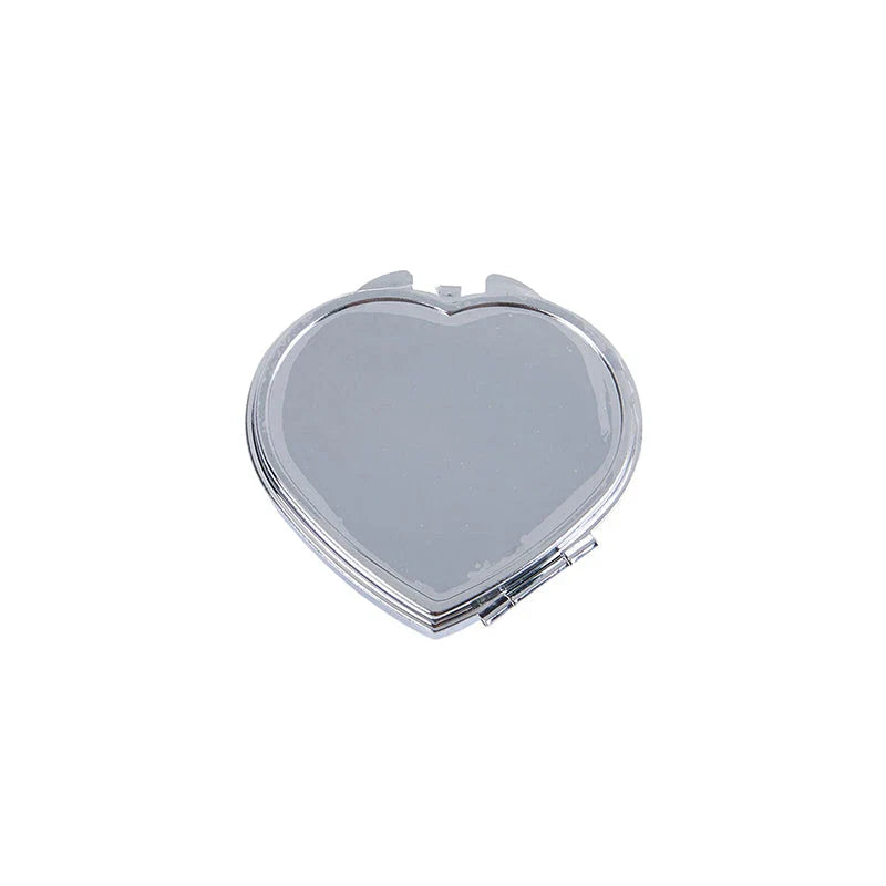 Heart-shaped metal pill box with built-in mirror for convenient storage and touch-ups on the go