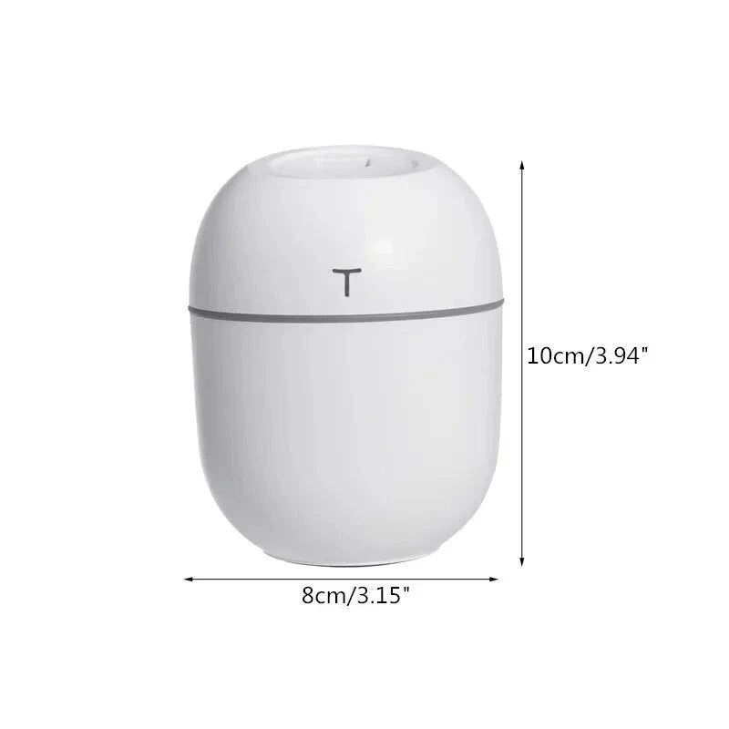 Compact ultrasonic humidifier and aroma diffuser with LED night light, designed for use in home or office spaces.