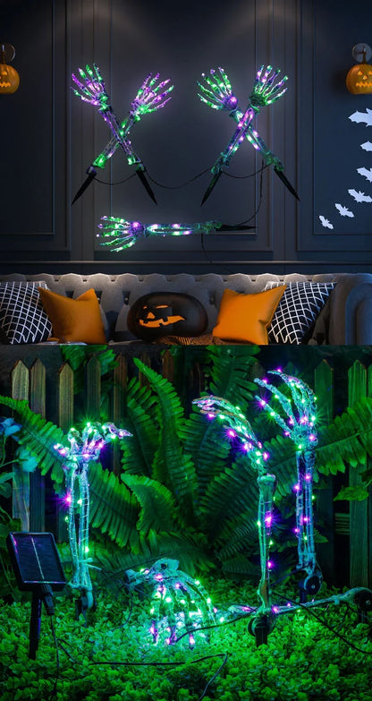Solar-powered Halloween ground lamp with hand-shaped LED lights in purple and green colours, creating a spooky ambience in an outdoor courtyard