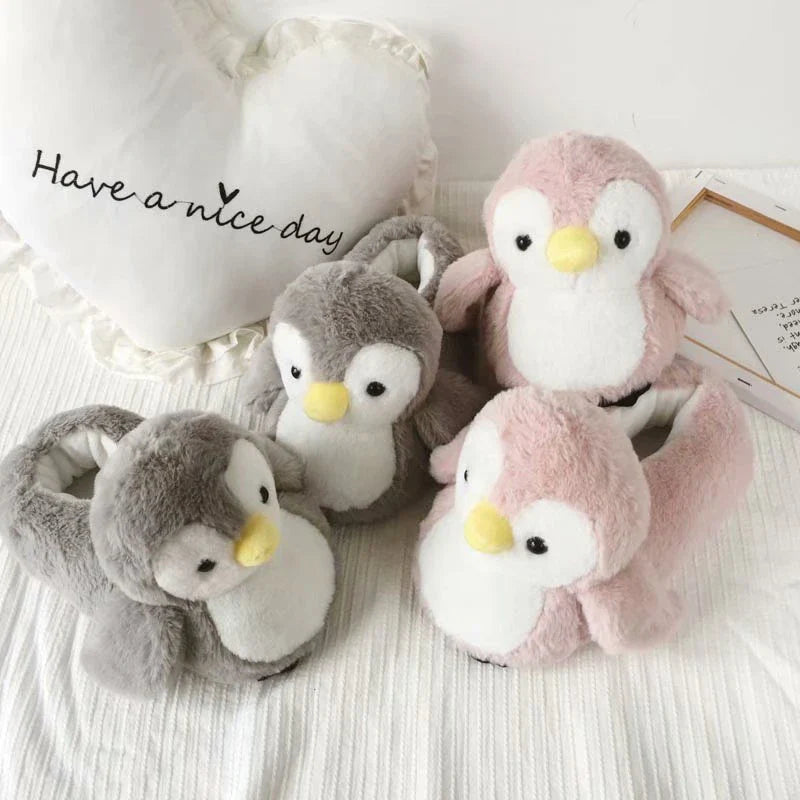 Pair of cosy, plush home slippers featuring a playful penguin design