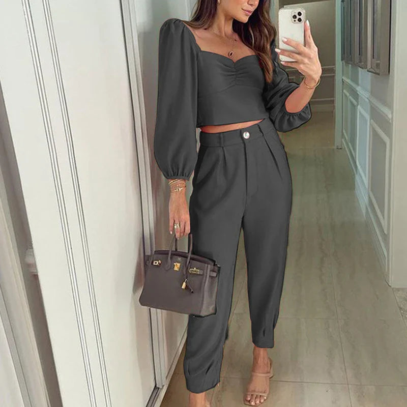 A stylish two-piece set with a square neckline top and ankle-tie trousers, made of premium polyester fabric and available in a range of vibrant solid colours.