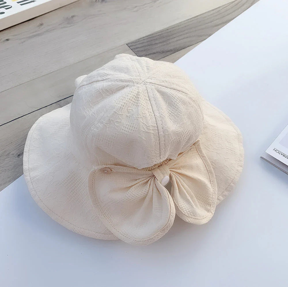 Adorable pink princess baby bucket hat with bow detail for sun protection and fashionable wear