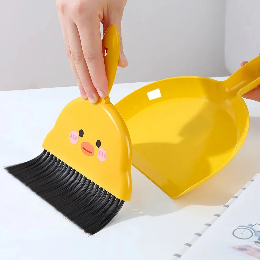 Compact table broom and dustpan set for children, featuring a yellow broom and dustpan made of durable materials for easy cleaning and tidying of small spaces.